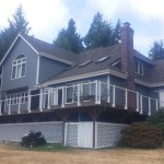 Rear of home showing siding, decks, railings and lattice